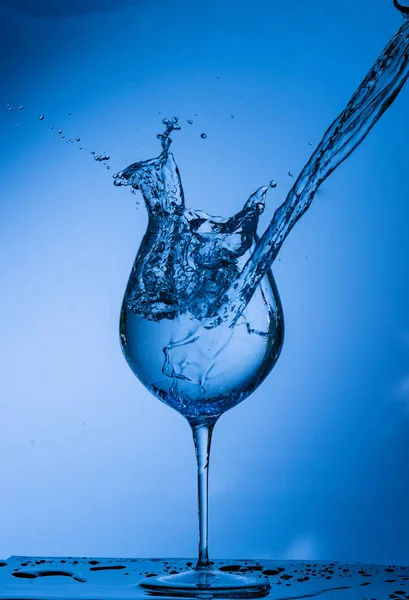 water, glass, drink, splash, liquid, pouring, blue, isolated, drop, white, beverage, fresh, cold, alcohol, clear, splashing, wine, object, clean, bubble, transparent, pour, cocktail, ice,