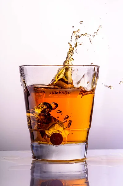 Whiskey Splashes Glass Light Background — Stock Photo, Image