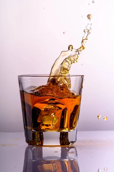Whiskey Splashes Glass Light Background2 — Stock Photo, Image
