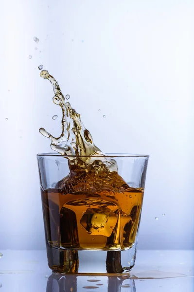Whiskey Splashes Glass Light Background5 — Stock Photo, Image