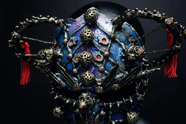 Iron mask with precious stones  on background,close up