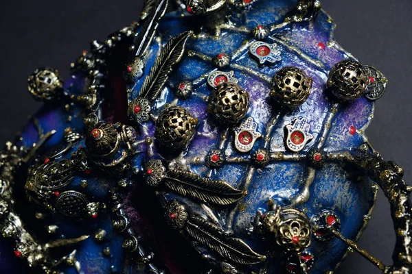 Iron mask with precious stones  on background,close up