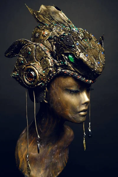 Bronze head of mannequin in decorated bronze kokoshnick, dark studio background