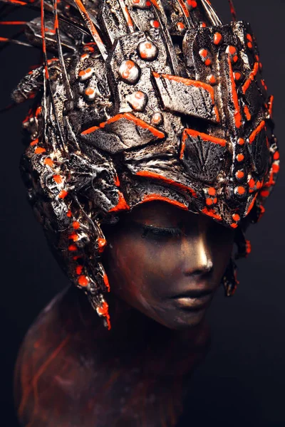 Bronze head of mannequin in decorated bronze kokoshnick, dark studio background