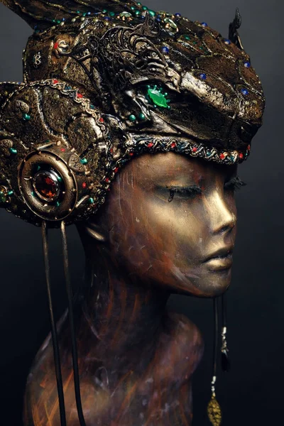 Bronze head of mannequin in decorated bronze kokoshnick, dark studio background