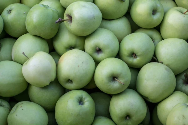 A box of Green Apples for sale in a farmers market