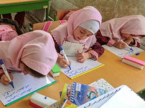 Rasht, Guilan eyaletinde, İran'da ilkokul kızlarından biri. Kızların eşarp giymesi ve üniforma giymesi gereken bir İslam okulu.