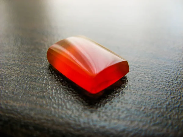 Yemeni red aqeeq agate stone.Yemeni opal red stone. Yemeni agate red stone. closeup of natural yemen aqeeq on dark table. Muslims use agate stone as a holy stone