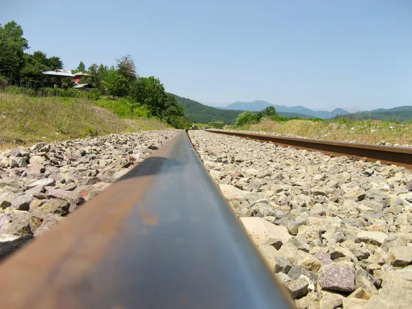 Train Track Sleepers Railroad tracks. Train tracks going through the  forest and mountains.Crossing the railway line from the countryside area.