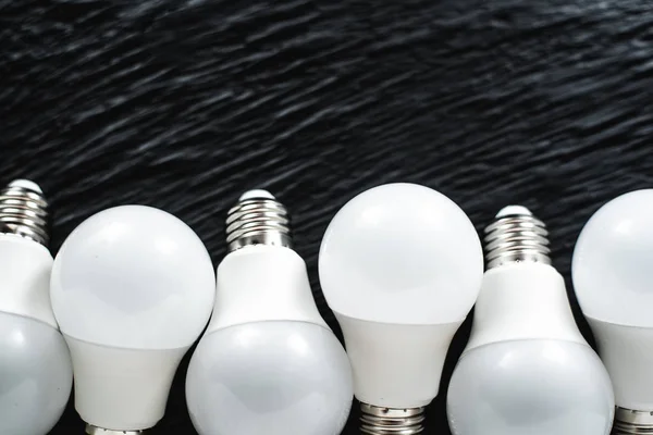 led light bulbs white light on black textured background