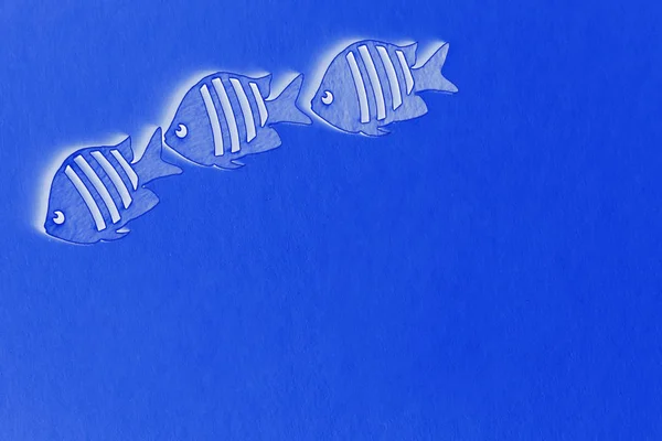 three fish on a blue background, plenty of room for text