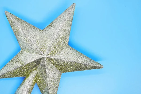 Christmas star closeup on a blue background, Christmas card, Christmas background, winter traditional holidays