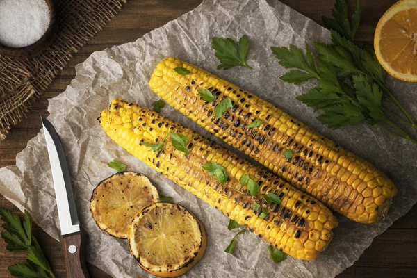 Delicious Grilled Mexican Corn with parsley, grilled lemon and salt.