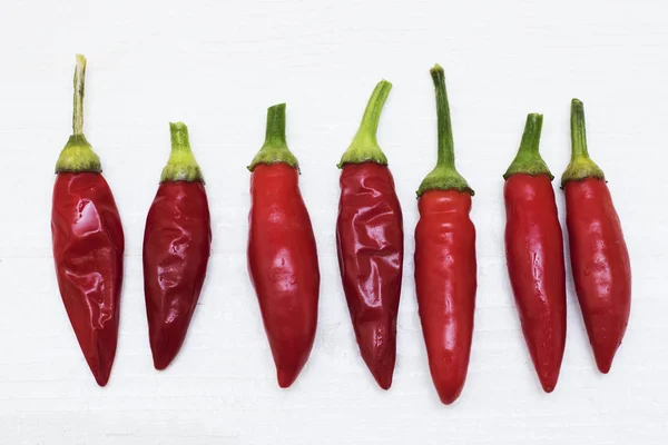 Red Hot Chili Peppers on light wooden background. Copy space for text. Ugly Red Hot Chili Peppers.