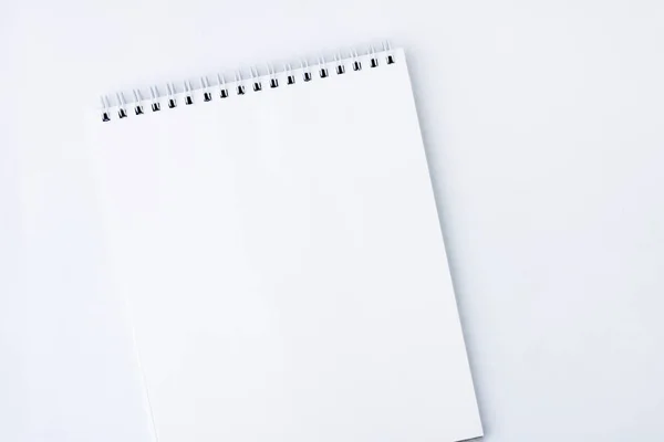 White open notebook. White notebook with spiral mount pages, on a white background. Copy space