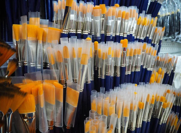 Yellow and blue brushes for painting in the art shop