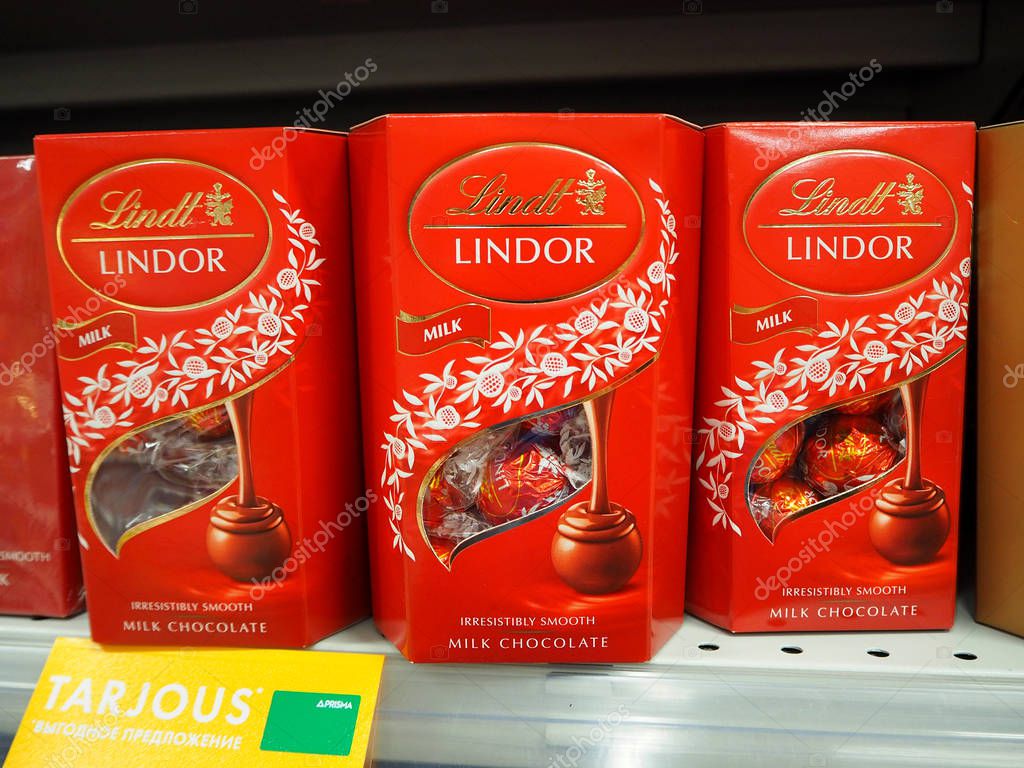 St.Petersburg, Russia. 07.30.2019. Lindt Lindor milk chocolate in the red box on the supermarket shelf. Lindt is a Swiss chocolatier and confectionery company known for its chocolate truffles and chocolate bars, among other sweets.