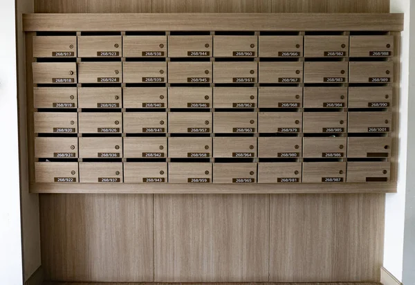 Close up of numbered mailboxes and lockers in raw in the condo . — стоковое фото
