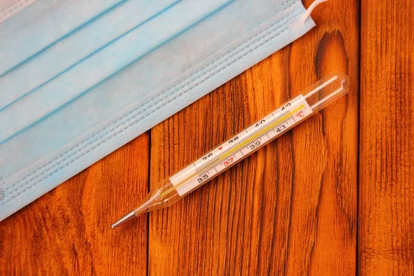 medical mask and mercury thermometer