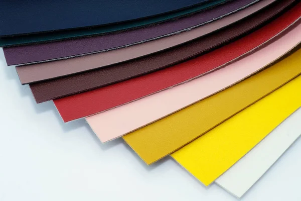 Color palette of imitation leather for upholstering furniture. Eco leather for the manufacture of bags, wallets and product decoration. Various colors of textile samples, sewing production.