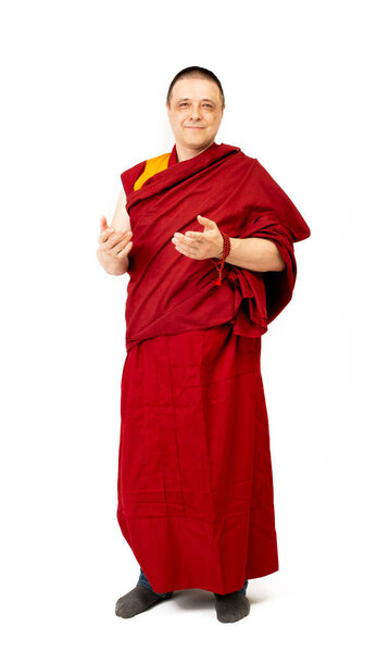 Porter of a Tibetan Mongolian monk in ritual red clothing on a white background
