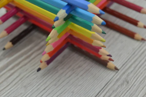 Pencils are arranged in colors. Gradient from pencils rainbow. Figures from pencils for drawing
