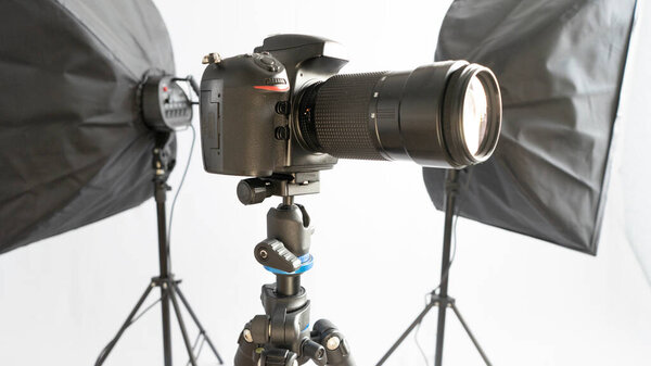 Dslr camera on tripod wirt two soft box. Studio set for shooting