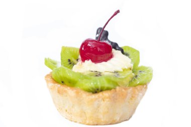 Kivili ve kremalı pasta, turuncu dilimlerin yanında. Beyaz arkaplan