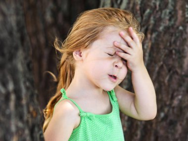 Unuttuğun bir şey şirin küçük kıvırcık saçlı sarışın kız facepalming