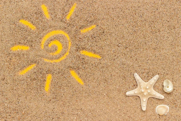 Sun sign drawn and starfish, seashells on sand. Creative top view Copy space Top view