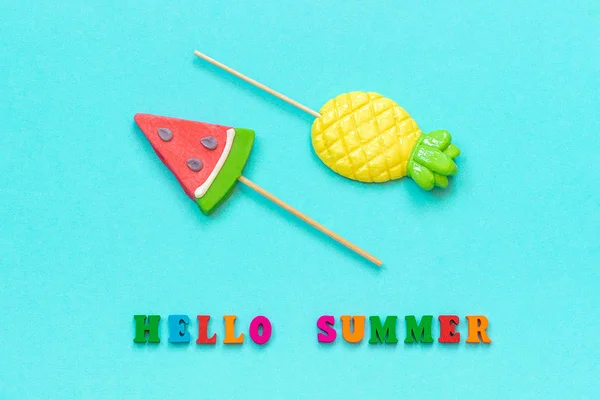 Hello summer colorful text, pineapple and armelon lollipops on stick on blue paper background. Концепция отдыха или праздников Creative Top view Шаблоны Открытки, открытки — стоковое фото