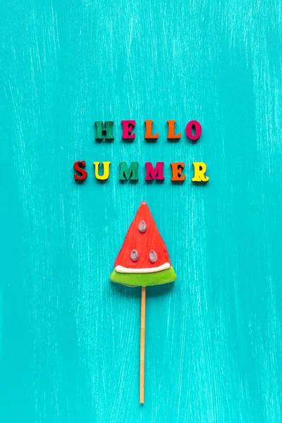 Hello summer text from colorful letters and watermelon lollipop on stick on wooden blue background. Concept Creative Top view Template Greeting card — Stock Photo, Image