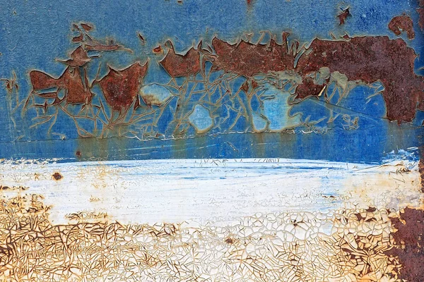 Old rusty metal background with cracked peeling blue and white p