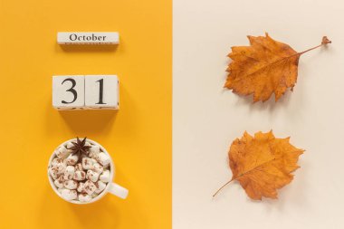 Sonbahar kompozisyonu. Ahşap takvim 31 Ekim, sarı bej arka plan üzerinde marshmallow si lik kakao ve sarı sonbahar yaprakları. Üstten düz yatıyordu Mockup Concept Merhaba Eylül