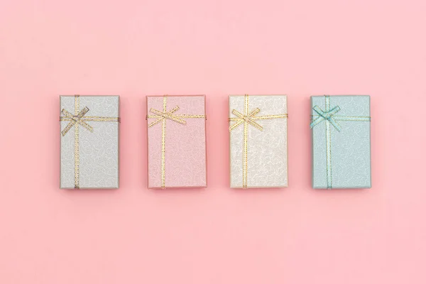 Set of gift boxes of pastel colors on pink background, Top view