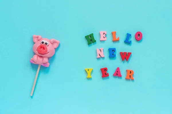 Pig lollipop and text Hello New Year — Stock Photo, Image