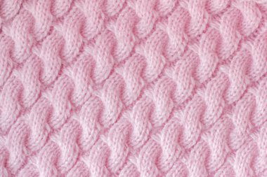 Yün iplik pembe renkten örme kumaş. Desen 