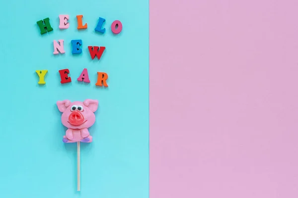 Pig lollipop and text Hello New Year — Stock Photo, Image