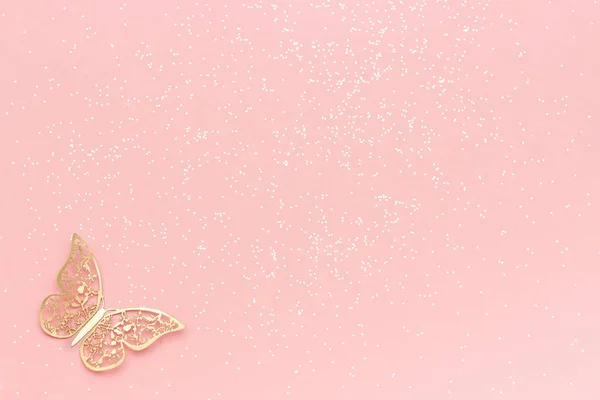 Sparkles glitter and gold tracery butterfly on pink pastel trendy background. Festive background, template — Stock Photo, Image