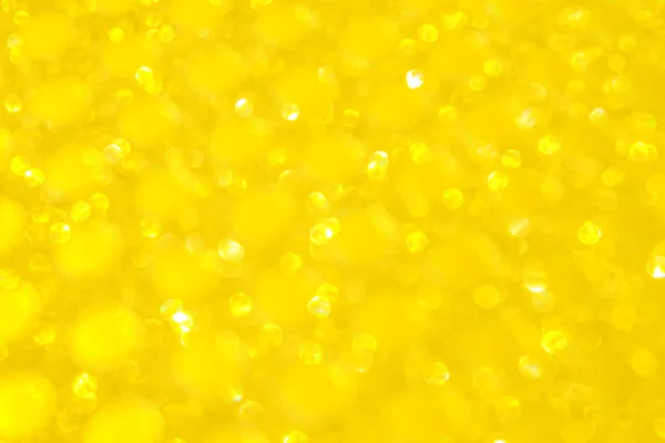 Bokeh defocused lights. Sparkling yellow golden abstract background or texture — Stock Photo, Image