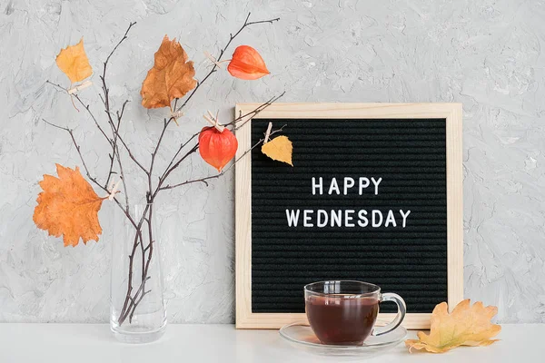 Happy Wednesday text on black letter board and bouquet of branches with yellow leaves on clothespins in vase on table Template for postcard, greeting card Conceito Olá outono quarta-feira — Fotografia de Stock