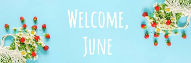 Welcome June text. Bouquet of white chamomile in reusable shopping eco mesh bag and splash red strawberries on blue background. Concept Hello summer. Banner Top view. clipart