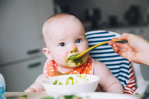 Feeding Messy Smiling Baby Eating Spoon High Chair Baby First — Stock Photo, Image