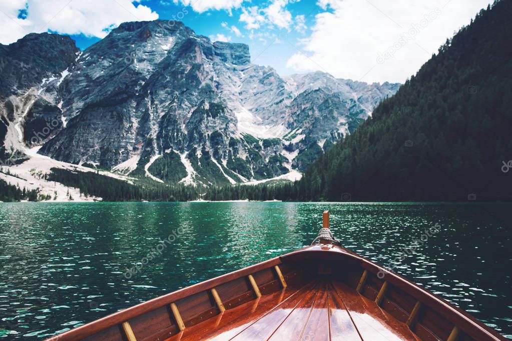 Traditional wooden rowing boats on italian alpine Braies Lake at summer. Lago Di Braies is largest natural lake in Dolomites, South Tyrol, Italy, Europe.