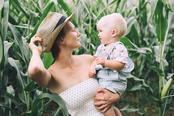 Mother and baby outdoors. Family on nature.