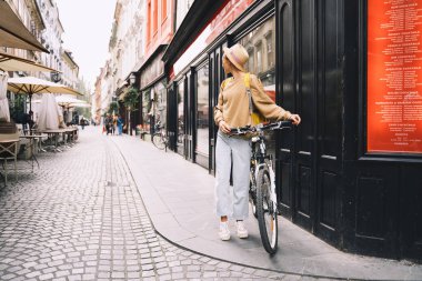 Sırt çantası ve bisikleti olan kız Ljubljana 'yı keşfediyor. Slovenya 'ya Seyahat