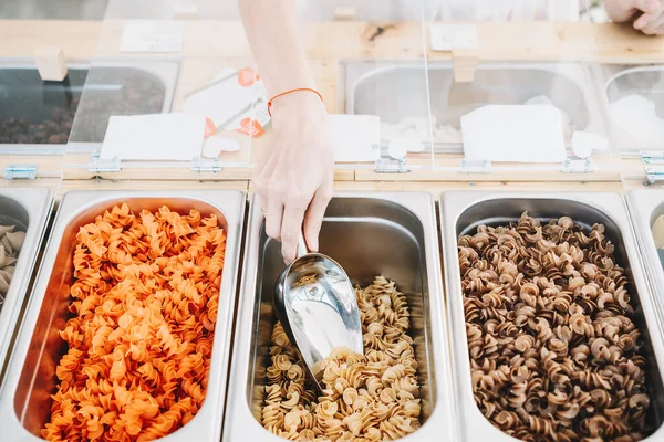 Zero waste shop. Woman buying dry goods in plastic free grocery store