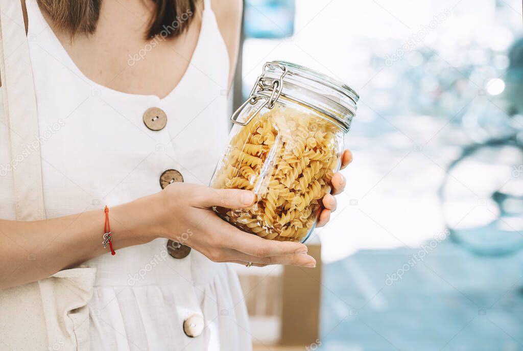 Zero waste shop. Woman buying products in plastic free grocery store