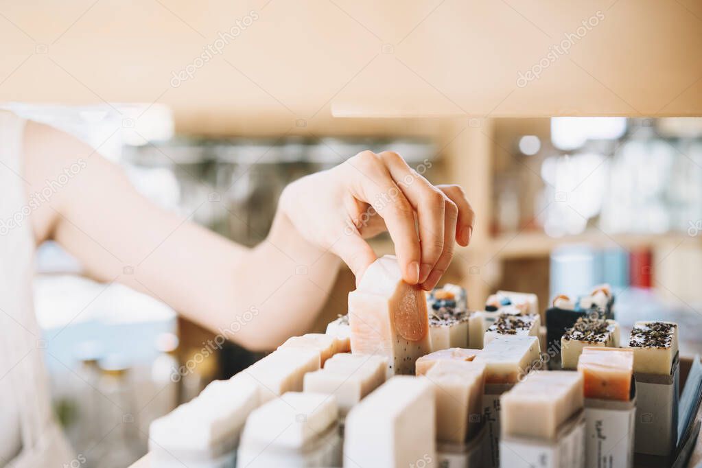 Woman with personal hygiene items in zero waste shop.