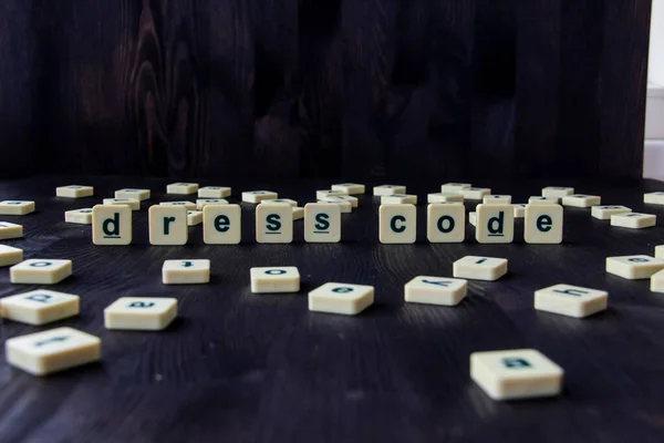 Word or phrase DRESS CODE made with  letters on the wood, great image for your design.